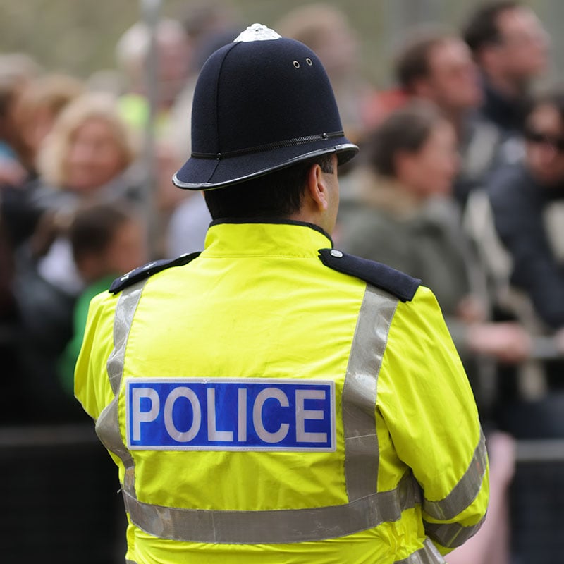 Police officer looking at a crowd of people Police officer looking at a crowd of people